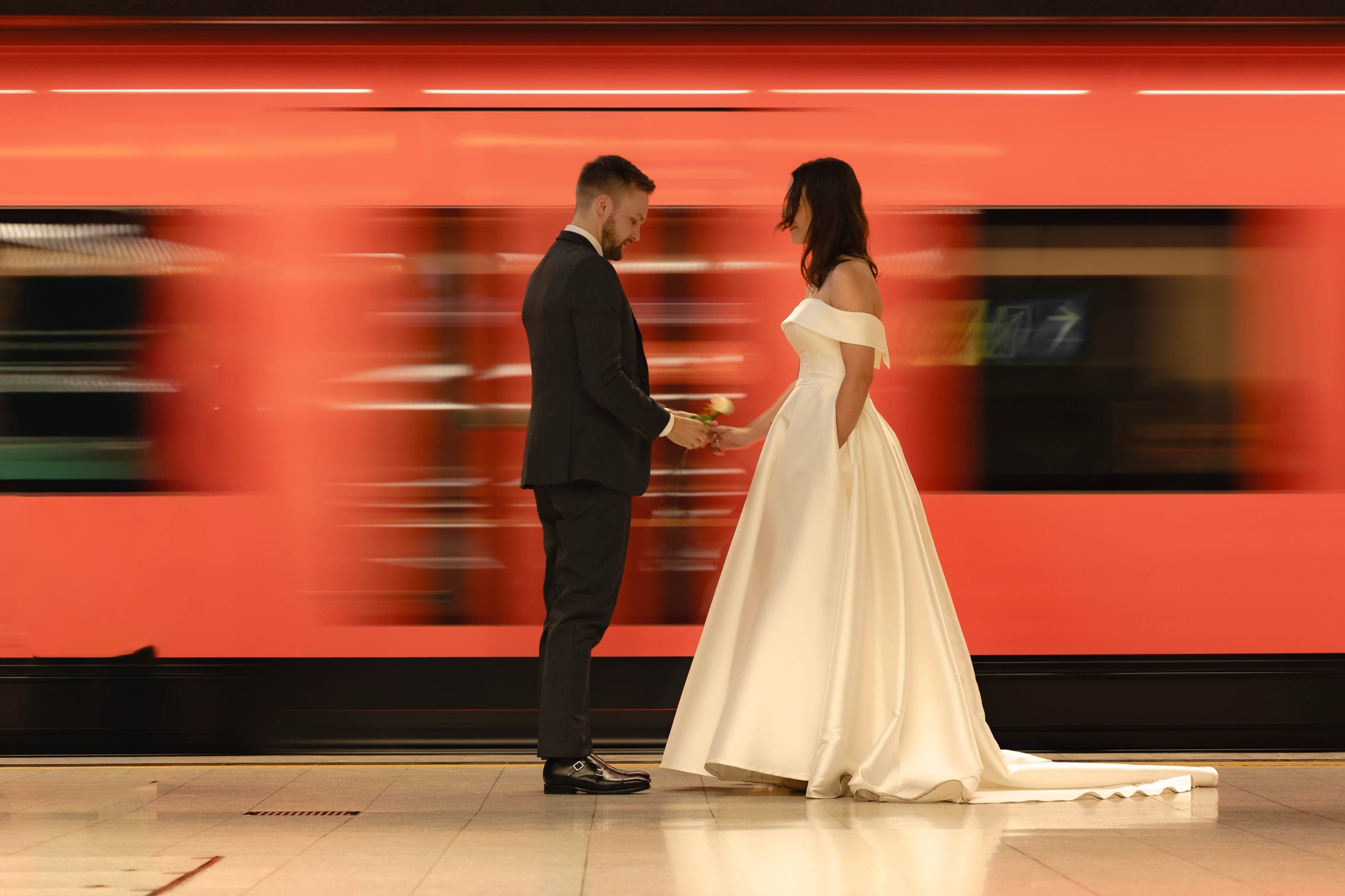 Couple in front of a passing train